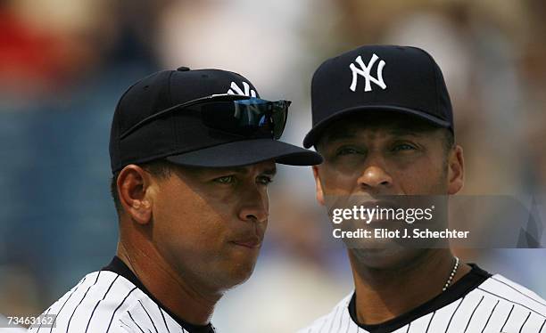 Third baseman Alex Rodriguez of the New York Yankees lines up with teammate short stop Derek Jeter before the start of the game against the Minnesota...