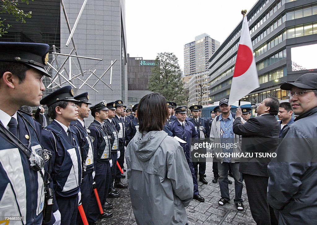 Japanese right-wing activists, hoisting a Japanese flag, protest ...