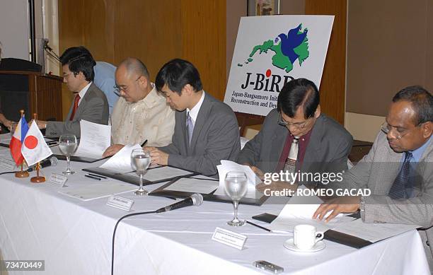 From left, Japan deputy chief of mission for Mindanao, Eiichi Oshima; Silvestre Afable, chairman of the Philippine government negotiating panel;...