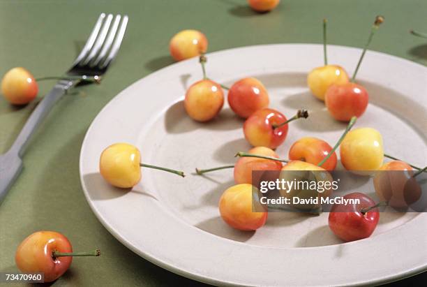rainier cherries on on ceramic dinner plate - rainier cherries stock pictures, royalty-free photos & images