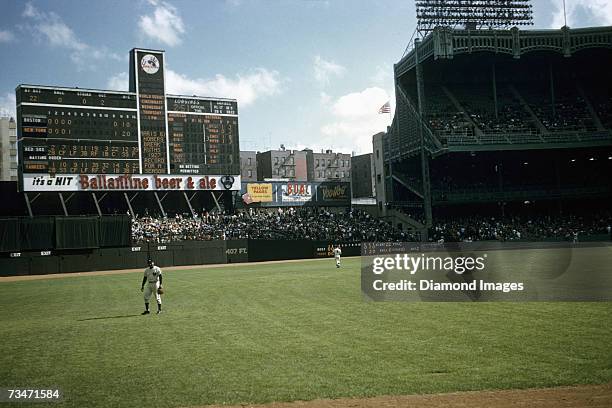 The scoreboard tells the story as outfielder Roger Maris , of the New York Yankees, takes his postion in centerfield during a game on October 1, 1961...