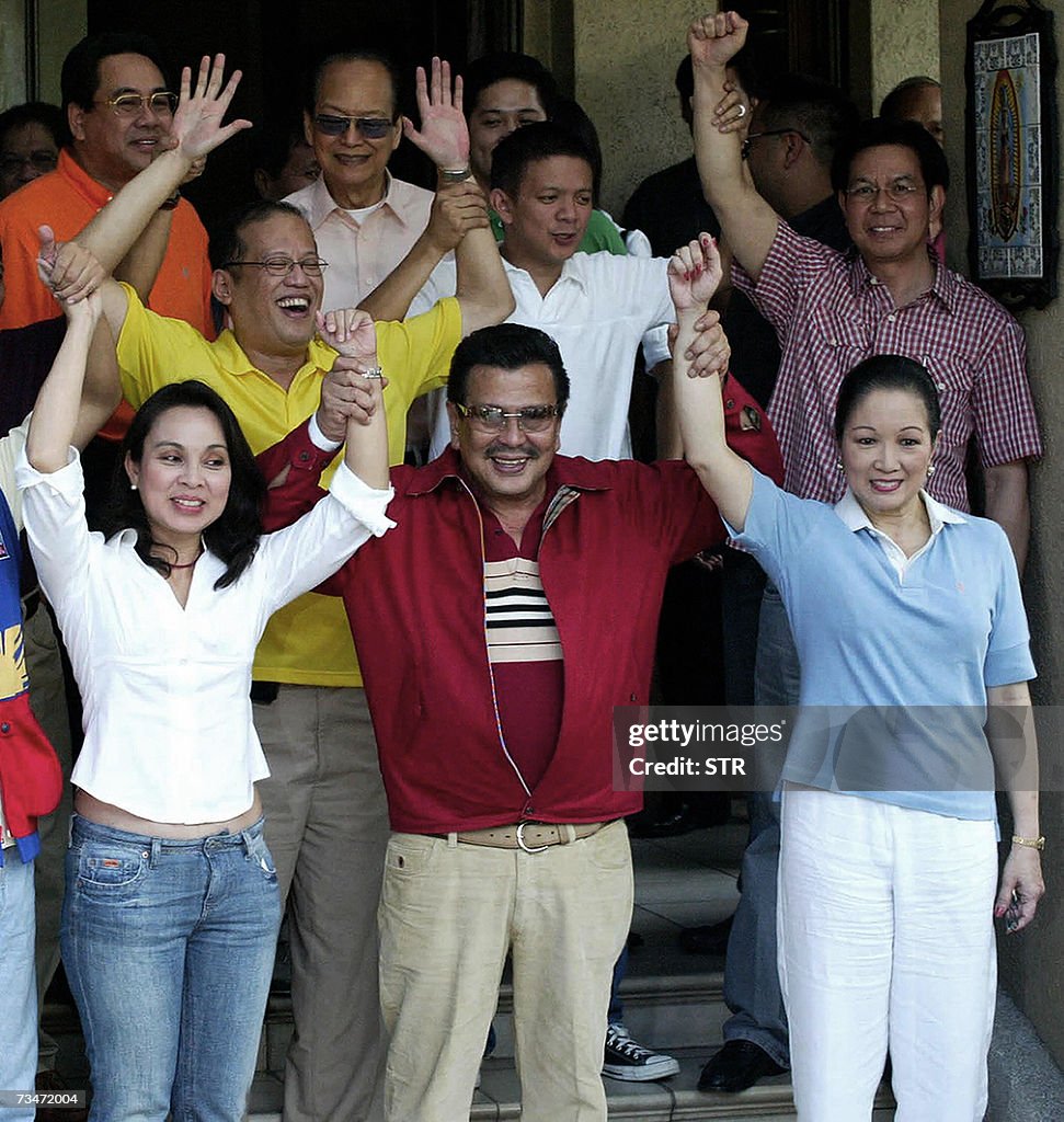Deposed Deposed Philippine President Joseph Ejercito Estrada raises the hands ...