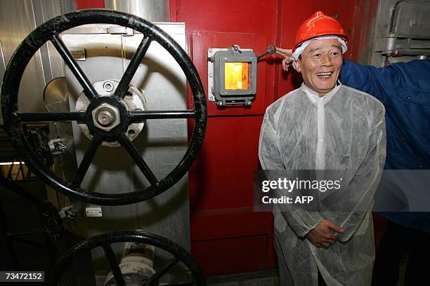 Amsterdam, NETHERLANDS: The Mayor of Beijing, Wang Qishan, poses at the waste recycling factory, Afval Energie Bedrijf, in Amsterdam during a visit...