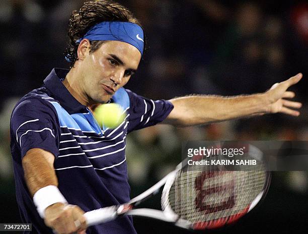 Dubai, UNITED ARAB EMIRATES: Roger Federer of Switzerland returns the ball to Tommy Haas of Germany during their ATP Dubai Tennis Championship...
