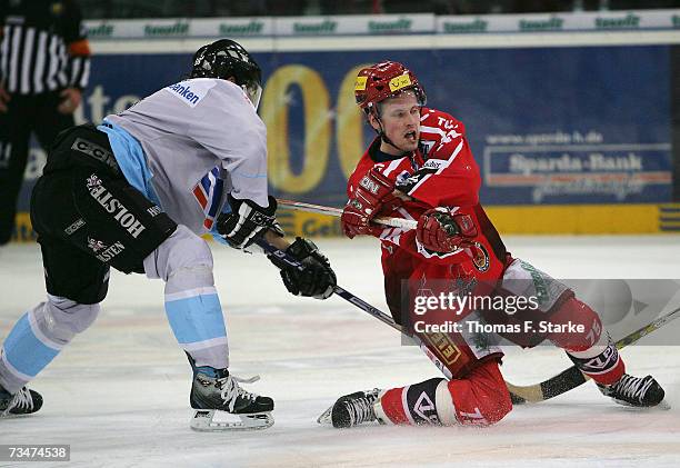 Benjamin Hinterstocker of Hamburg and Andreas Morczinietz of Hanover in action during the DEL Bundesliga game between Hanover Scorpions and Hamburg...