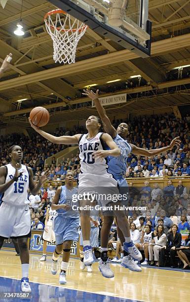 Lindsey Harding of the Duke Blue Devils makes a layup against Jessica Breland of the North Carolina Tar Heels on February 25, 2007 at Cameron Indoor...