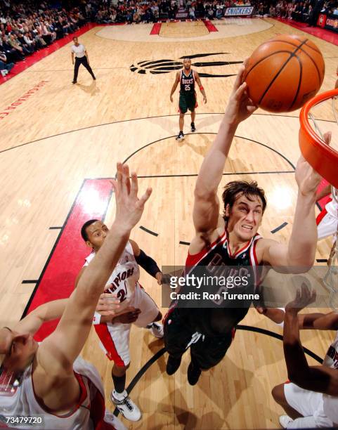 Andrew Bogut of the Milwaukee Bucks takes the ball inside against three members of the Toronto Raptors on March 2, 2007 at the Air Canada Centre in...