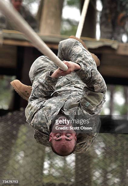 Mike Bowen of Hudson, New Hampshire works his way down a rope on a confidence course during Army basic training at Fort Jackson March 1, 2007 in...