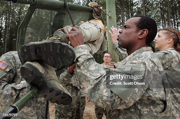 Brian Elisha of Burlington, New Jersey helps fellow soldiers at a teamwork drill during Army basic training at Fort Jackson March 1, 2007 in...