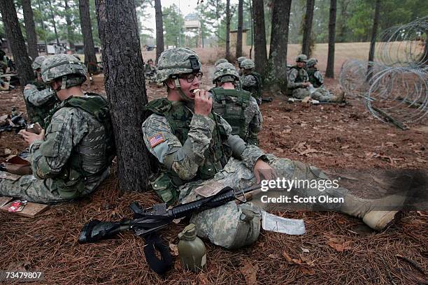 Andrew Hay of Butler, Pennsylvania eats lunch at rifle range during Army basic training at Fort Jackson March 1, 2007 in Columbia, South Carolina. In...