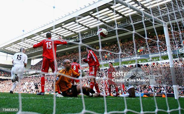 John O'Shea of Manchester United celebrates scoring the winning goal as goalkeeper Jose Reina of Liverpool shows his dejection during the Barclays...