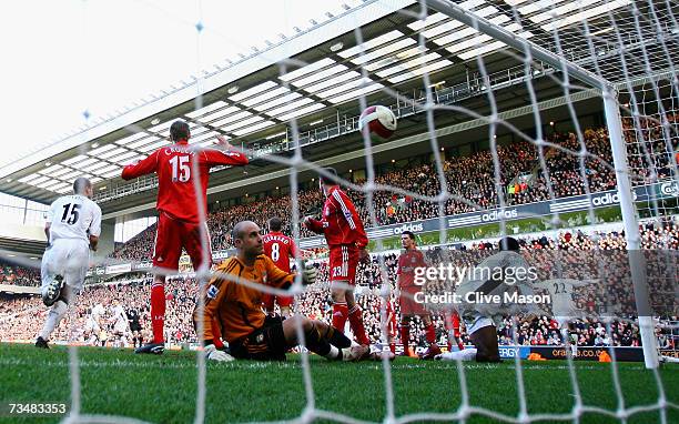 John O'Shea of Manchester United celebrates scoring the winning goal as goalkeeper Jose Reina of Liverpool shows his dejection during the Barclays...