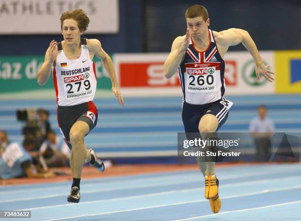 Craig Pickering of Great Britain competes with Christian Blum of Germany during the Men's 60 Metres Semi-final on day two of the 29th European...