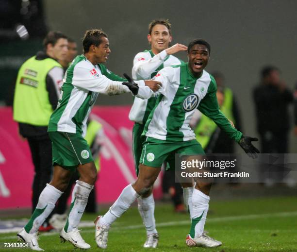 Cedrick Makiadi of Wolfsburg celebrates scoring his goal with Marcelinho and Jonathan Santana during the Bundesliga match between VFL Wolfsburg and...