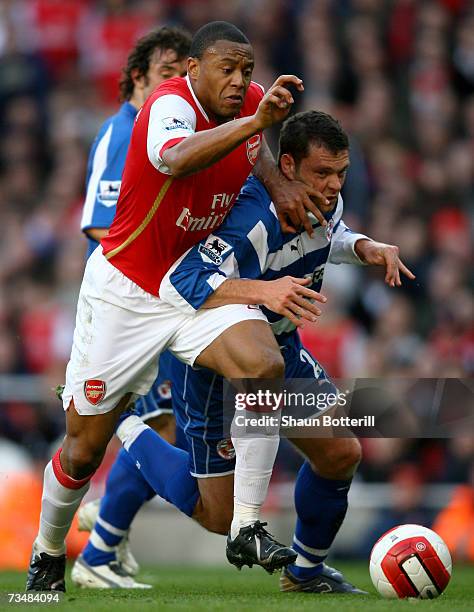 Julio Baptista of Arsenal hold off the challenge of Graeme Murty of Reading to score his sides second goal during the Barclays Premiership match...