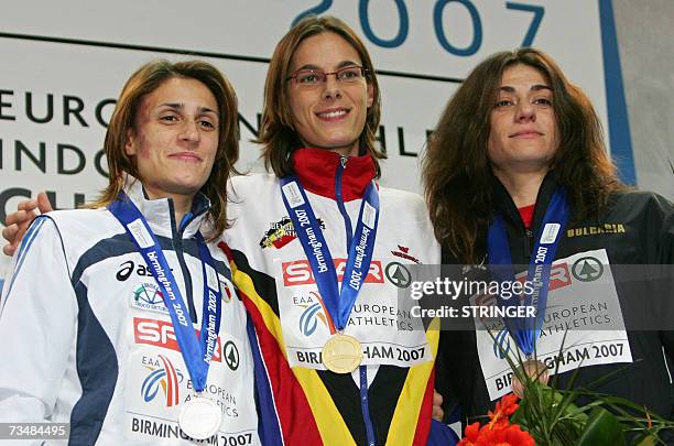 Birmingham, UNITED KINGDOM: Italian Antonietta di Martino, Belgian Tia Hellebaut and Bulgarian Venelina Veneza show their medals on the podium of the...