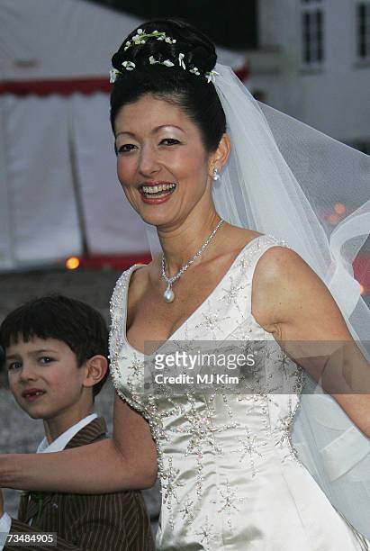 Princess Alexandra of Denmark and her son Prince Nicolai pose for photographers after her wedding ceremony to photographer Martin Jorgensen at Oster...