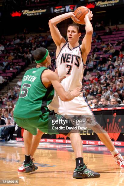 Bostjan Nachbar of the New Jersey Nets passes against Gerald Green of the Boston Celtics on March 3, 2007 at Continental Airlines Arena in East...