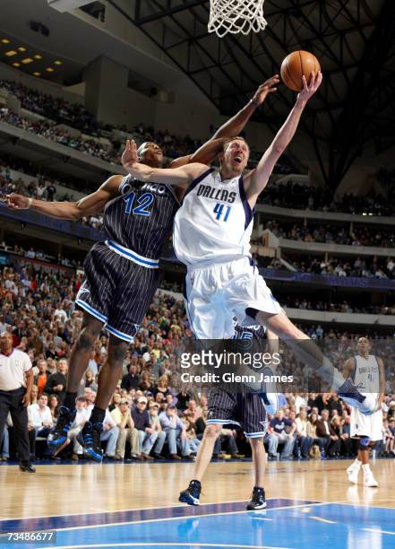 Dirk Nowitzki of the Dallas Mavericks converts the bucket and draws the foul from Dwight Howard of the Orlando Magic on March 3, 2007 at the American...