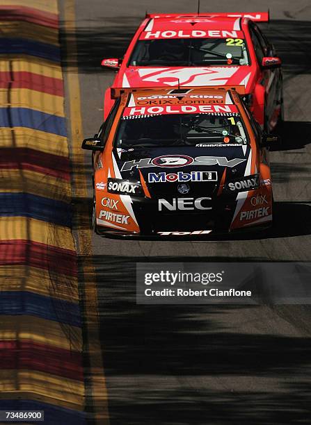 Rick Kelly of the Toll HSV Dealer Team holds off Todd Kelly of the Holden Racing Team during race two of the Clipsal 500 V8 Supercars on the Adelaide...