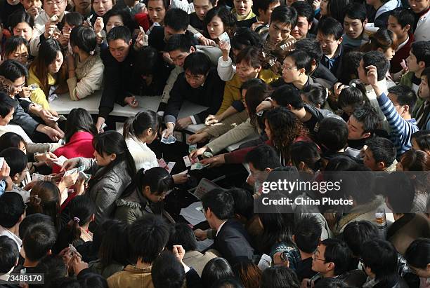 Job hunters jostle to buy admission tickets for the Chongqing Springtime Job Fair at Chongqing International Convention and Exhibition Center on...