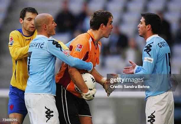 Berkant Goektan , Nemanja Vucicevic of 1860 Munich, goalkeeper Thorsten Stuckmann and Martin Horecek of Braunschweig argue during the Second...