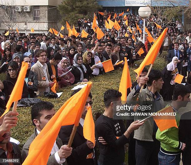Iraqi Kurdish students wave orange flags as they hold an Ukrainian-style "orange protest" in the northern city of Sulaimaniyah 04 March 2007, to...