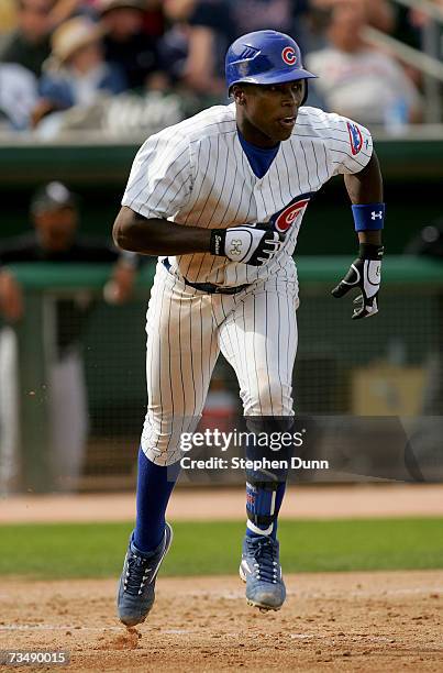 Alfonso Soriano of the Chicago Cubs runs to first as he picks up his third hit of the game against the Chicago White Sox during Spring Training at...