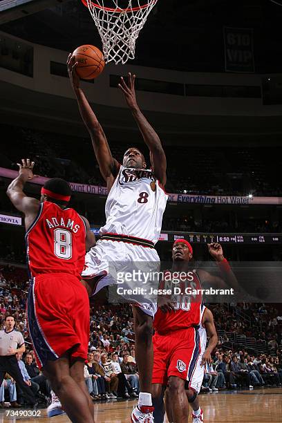 Joe Smith of the Philadelphia 76ers shoots against Hassan Adams of the New Jersey Nets on March 4, 2007 at the Wachovia Center in Philadelphia,...