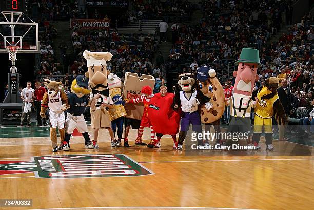 Mascots race while they are tied together at their ankles during the Milwaukee Bucks Annual Relay Challenge during a timeout in the NBA game between...