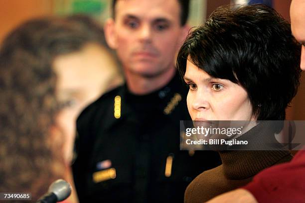 Macomb County Sheriff Mike Hackel watches as Alicia Standefer, the sister of murder victim Tara Lynn Grant, delivers a statement about her sister at...
