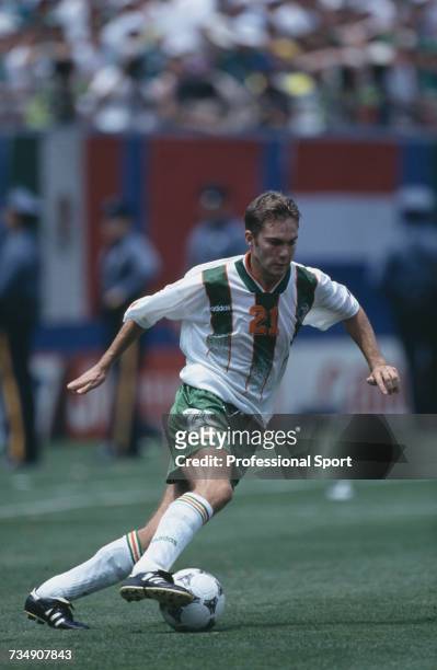English born footballer and midfielder with the Republic of Ireland team, Jason McAteer pictured making a run with the ball during the 1994 FIFA...
