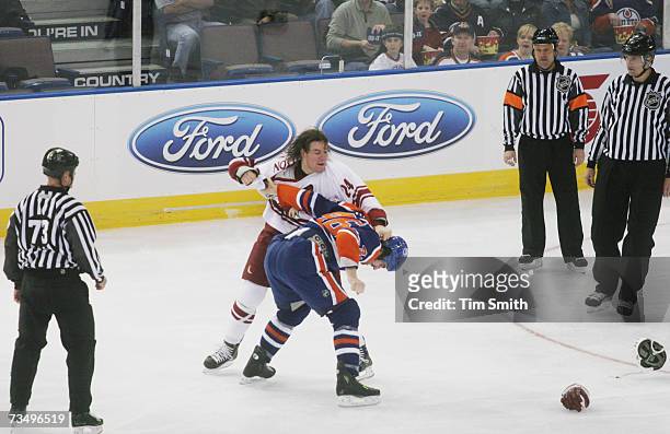 Josh Gratton of the Phoenix Coyotes throws a punch at Zack Stortini of the Edmonton Oilers during a fight in the NHL game at Rexall Place on February...