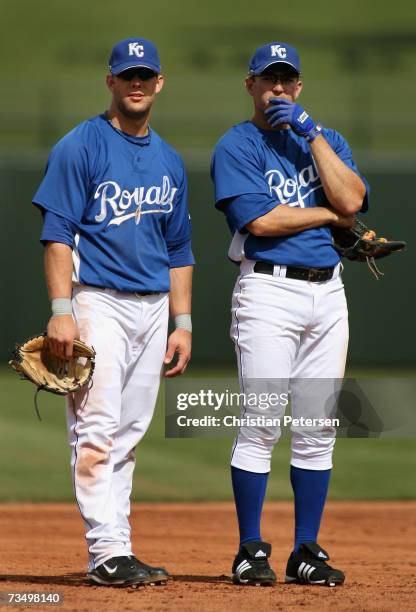 Infielders Alex Gordon and Alex Gonzalez of the Kansas City Royals stand on the field during the MLB spring training game against the San Diego...