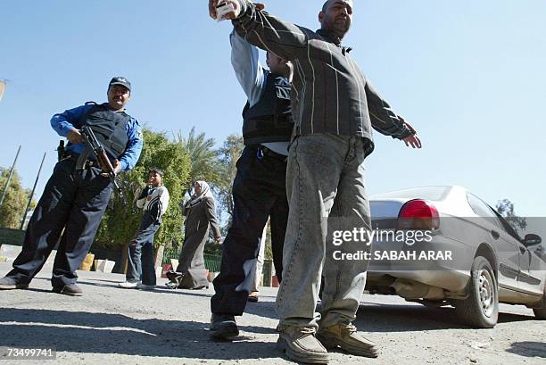Iraqi police offciers frisk a driver in Baghdad 06 March 2007. There can be few jobs anywhere in the world more terrifying than that of a Baghdad...