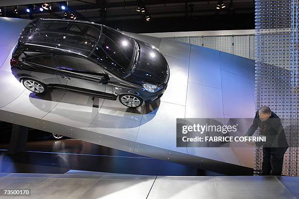 Visitor takes a picture of an Opel Corsa during the press day of the 77th Geneva Motor Show, 06 March 2007 in Geneva. The first European show this...