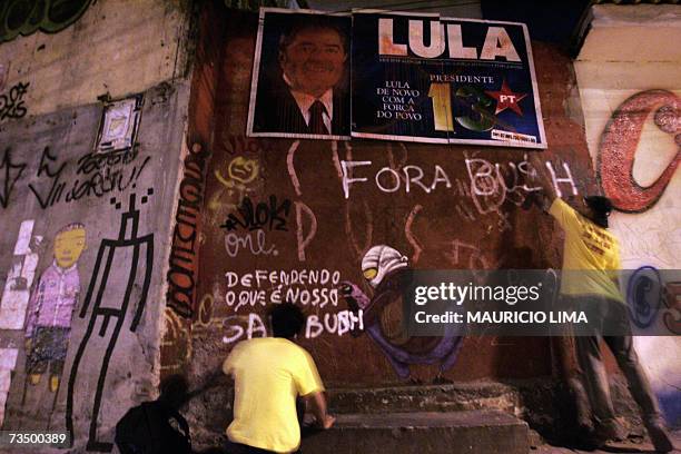 Brazilian students paint slogans against the USA's President George W. Bush on 06 March 2007 early morning near a recently defaced electoral campaign...