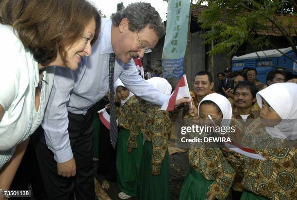 Australian Foreign Minister Alexander Downer , accompanied by his wife Nicky Downer , talks with students as he attends the opening ceremony of an an...