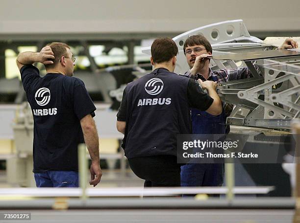 Employees work on the assembly of the tail of an Airbus A380 at the Airbus factory March 6, 2007 at Stade, in northern Germany. Airbus has announced...