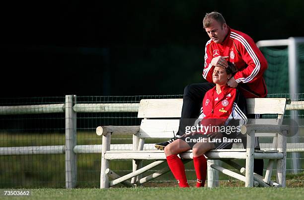 Bernd Lasarzewski streches the neck of Martina Mueller during the German Womens National team training session on March 6, 2007 in Albufeira,...