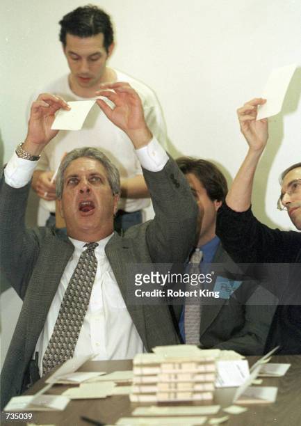 Charles Burton, center, chairman of the Palm Beach County, Florida, Board of Elections, views a ballot November 11, 2000 with observers from the Bush...