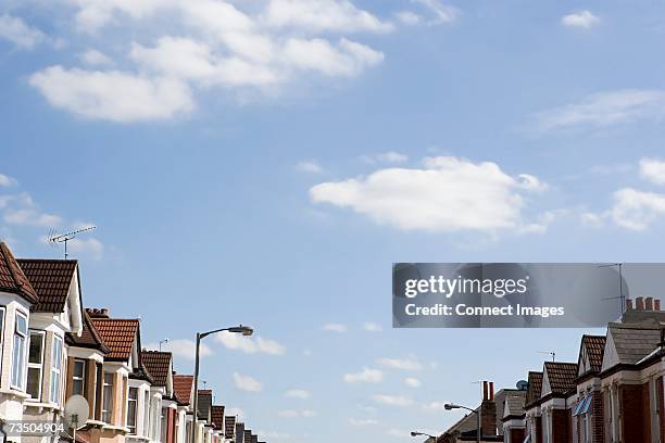 houses in a street - dachgiebel stock-fotos und bilder