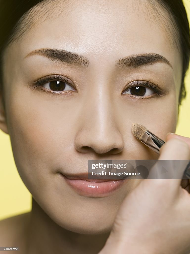 Woman applying foundation