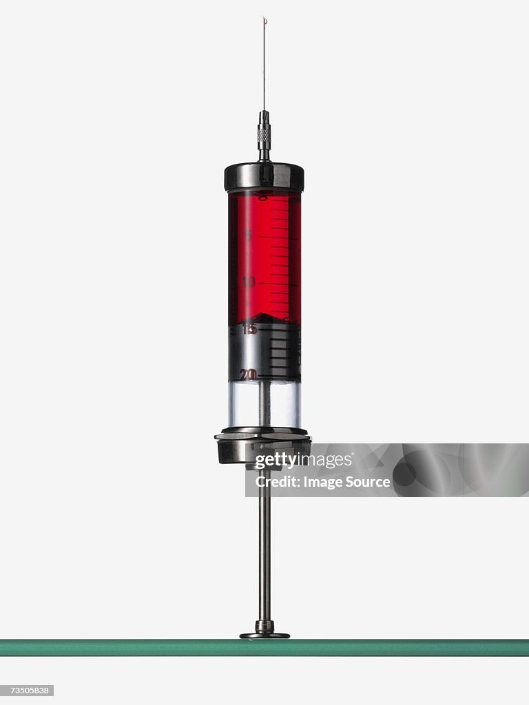 Syringe containing red liquid