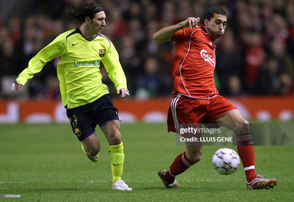 Liverpool's Alvaro Arbeloa (R) vies with...