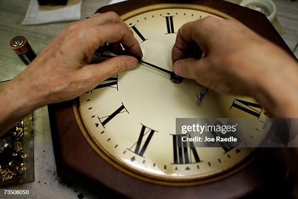 Howard Brown repairs a clock at Brown?s Old Time Clock Shop March 6, 2007 in Plantation, Florida. This year day light savings time happens three...