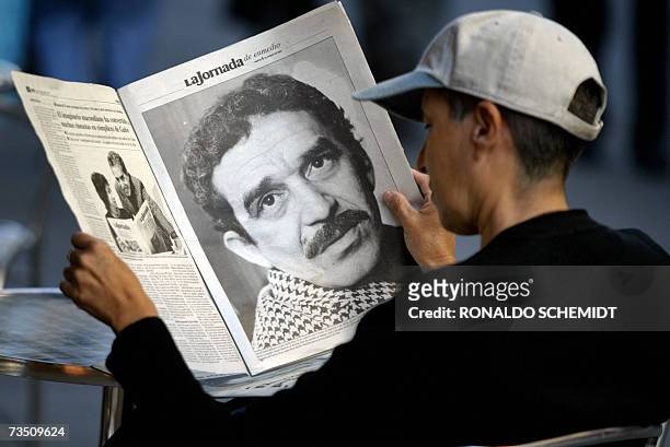 Young Mexican sitting in a cafe reads a newspaper which offers a special suplement dedicated to Colombian writer and Nobel Prize in Literature 1982...