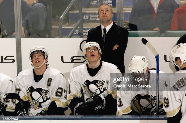 Sidney Crosby, Evgeni Malkin and Jordan Staal of the Pittsburgh Penguins sit on the bench during their NHL game against the Florida Panthers on...