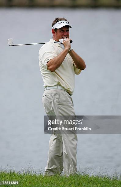 Lee Westwood of England plays an approach shot left-handed during the Pro -Am of The Clariden Leu Singapore Masters at Laguna National Golf Club on...