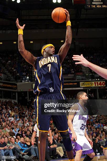Jermaine O'Neal of the Indiana Pacers grabs the rebound with one arm against the Sacramento Kings on March 6, 2007 at ARCO Arena in Sacramento,...
